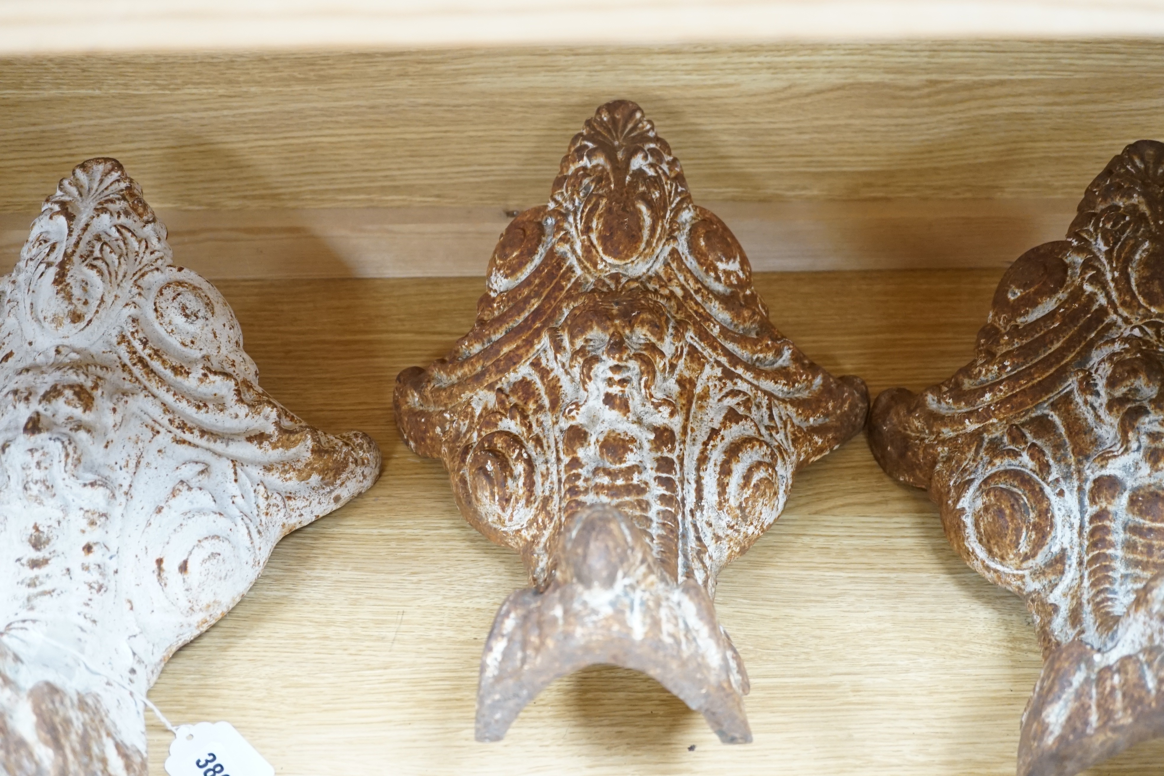 Three Victorian cast iron bath feet, 41cms high